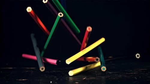 Colored Pencils Falling in Slow Motion on Surface