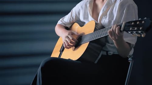 Girl Playing Guitar at Studio