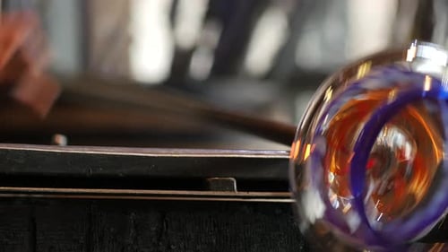 Glass Blower Shaping Artistic Glass Piece