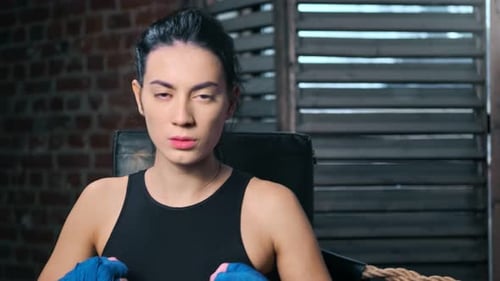 Female Boxer Wearing Hand Wraps in Boxing Ring