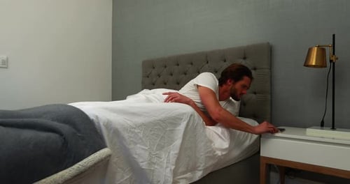 Man Wakes Up and Gets Out of Bed