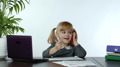 Girl Drawing and Talking on Smartphone at Desk