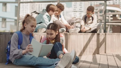 Group of School Kids Resting Outdoors in Summer