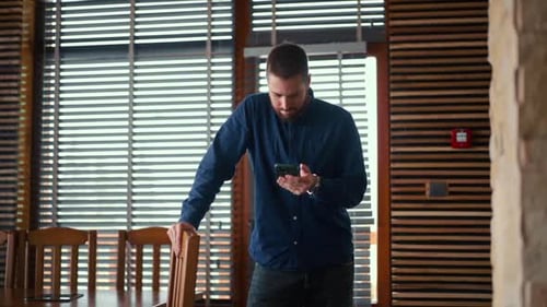 Young Adult Using Smartphone Indoors