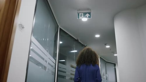 African American Businesswoman Walking Confident in Company Office Hallway