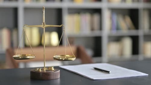 Scales of Justice with Contract on Table