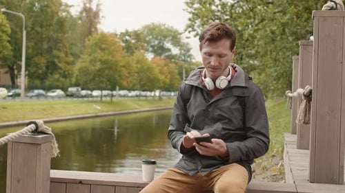 Man Calling on Phone on Pier