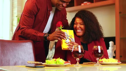 Woman Receives Gift and Rose from Romantic Partner