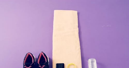 Workout Accessories Laying on Purple Surface