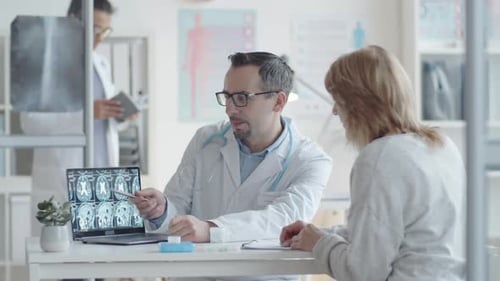Doctor Discussing Brain Scan with Patient in Office