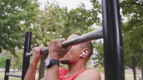 Side view man with prosthetic leg doing pull ups