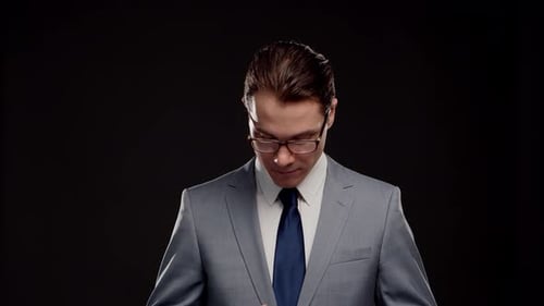 Studio portrait of successful and smart businessman in suit and tie.