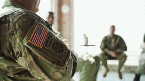 Soldiers Participate in Group Discussion Indoors