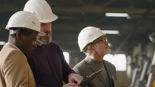 Businessmen Having Factory Tour with Female Manager