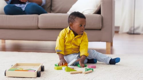 Boy Playing with Colorful Blocks on Rug