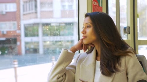 Slow motion shot of woman in a tram looking out of the window