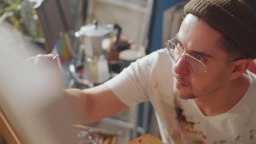 Young Creative Man Painting Picture in Art Studio