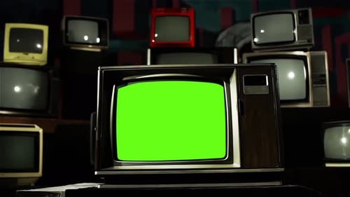 Old TV Set turning On Green Screen Among Many Retro TVs. Dolly Out. 4K Version.