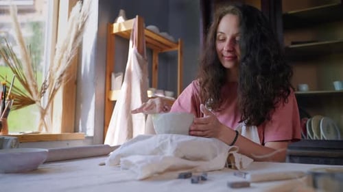 Woman Shaping Clay at Pottery Studio Table