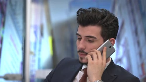Handsome Young Adult Talking on Smartphone