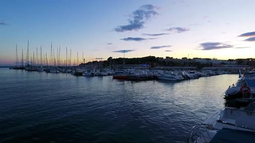 Sea Harbour with Boats and Buildings in Background - Sunset