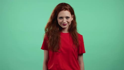 Young Woman with Red Hair Looking to Camera Smiling