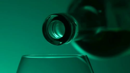 Poured From a Bottle Into a Glass of White Wine, Green, Closeup, Slowmotion