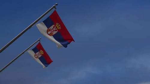 Waving Serbian National Flag Against a Blue Sky