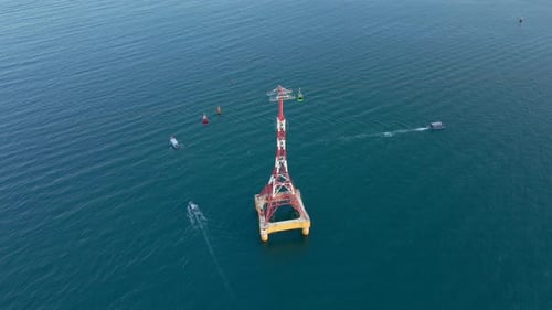 Aerial Slowmotion Shot of a Cable Car Over a Sea, Some Boats Float By