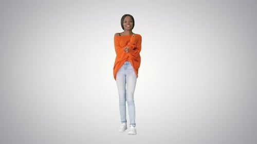 Young Casual African Woman Dancing on Gradient Background