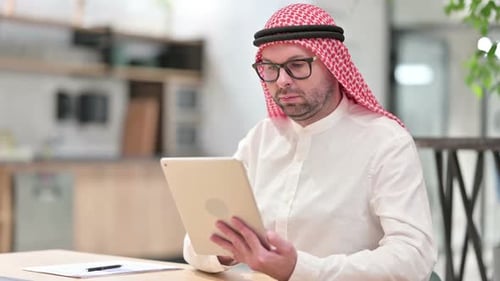 Professional Young Arab Businessman Using Tablet in Office