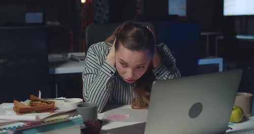 Front View Stressed Female Office Manager Working Late at Night and Tauching Head. Woman Swamped