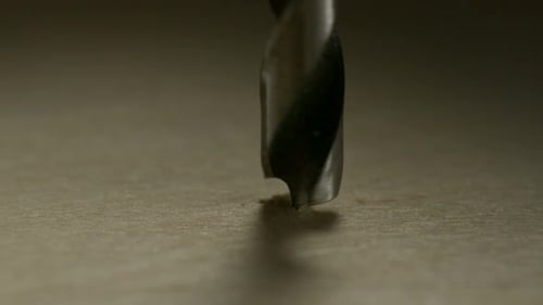 Drill bit drilling into wood in a close up