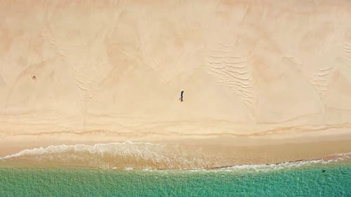 Aerial View of a Man Running Within Unspoiled Beautiful Beach