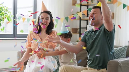 Cheerful Family Celebrating Birthday at Home with Confetti