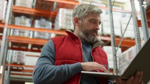 Warehouse Supervisor Working with Laptop