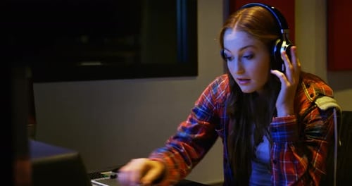 Female audio engineer using sound mixer