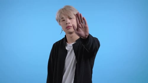 Asian Man Disapproving with NO Hand Sign Gesture