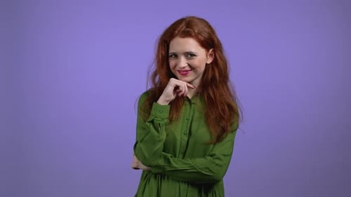 Young Woman with Long Red Hairstyle Looking to Camera Flirting
