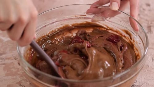 Mixing Chocolate Batter and Cherries with Spatula