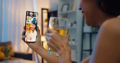 Woman Video Calling with Friends for a Virtual Celebration