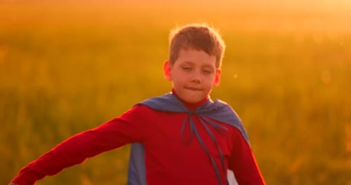 Child Superhero Running in Golden Field at Sunset