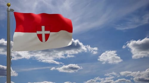 Waving Flag With Cross Shield Emblem Against Blue Sky