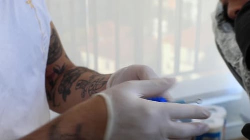 Man Prepares Tattoo Gun in Sterile Environment