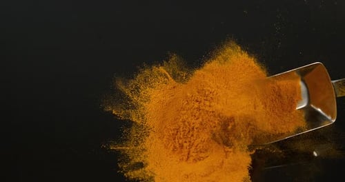 Turmeric, curcuma longa, Powder falling against Black Background, Indian Spice, Slow Motion 4K