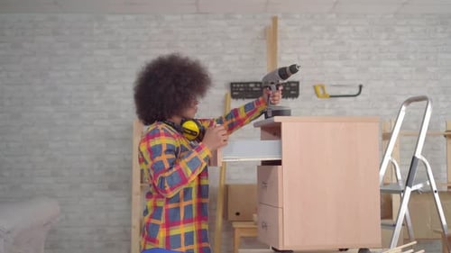 Portrait African Woman with an Afro Hairstyle with the Help of Tools Engaged in the Assembly