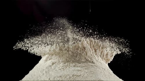 Egg Yolk Splashing in White Flour Mound