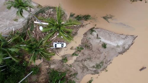 Aerial top down view car is flush away during flash flood and trap