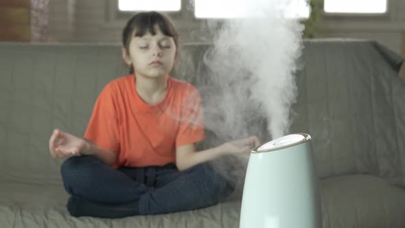 Girl Meditating Near a Humidifier Indoors, People Stock Footage ft ...