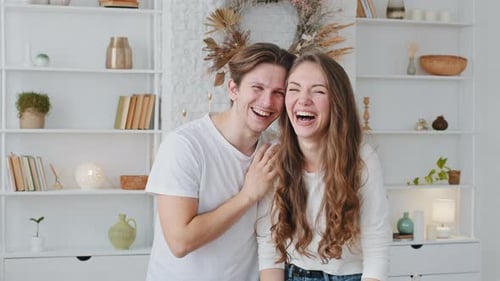 Playful Couple Laughing and Posing Indoors